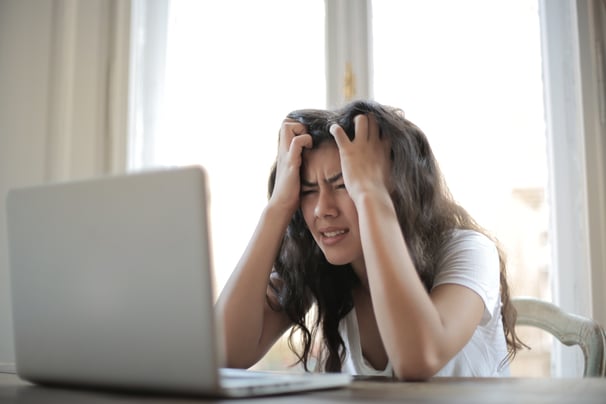 Canva-Woman-in-White-Shirt-Showing-Frustration