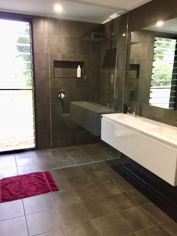 2 bedroom, 2 bathroom open plan modular home bathrooms with strip grates and wall hung vanities.